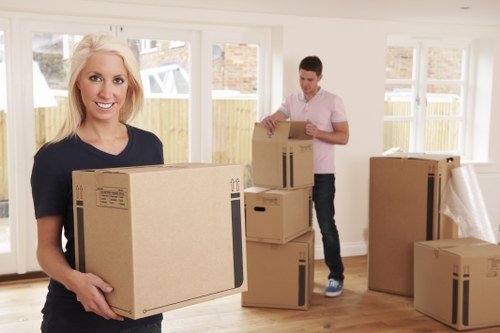 Professional movers handling office equipment in West Hampstead storage facility